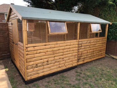 14 x 18 workshop in log lap cladding with two opening windows - earley